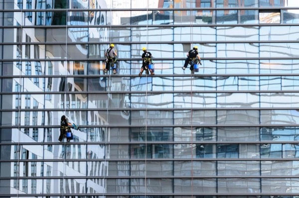 Window cleaners on a glass office building