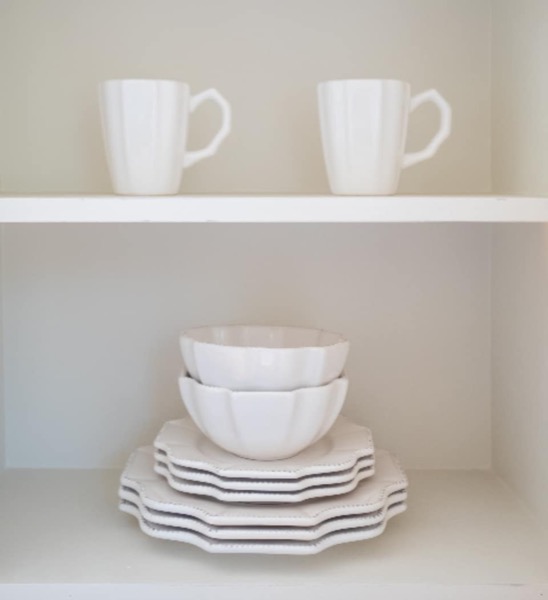 White mugs on a clean shelf